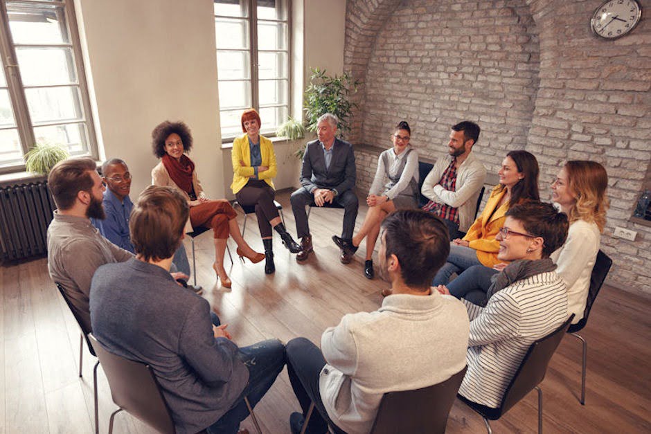 Men and women sharing during a group‑therapy meeting for Bend alcohol‑rehab program