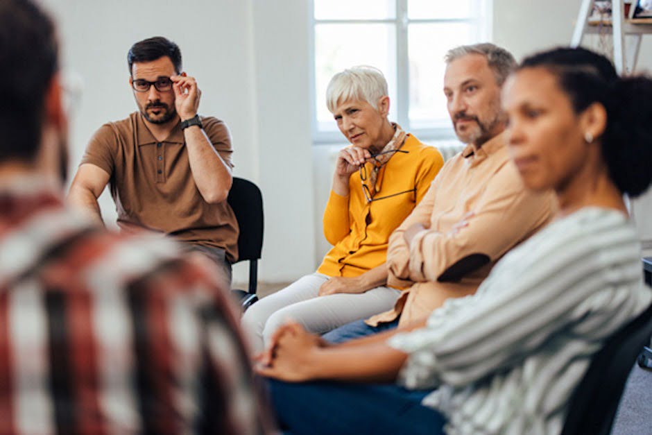 a group of people in addiction therapy