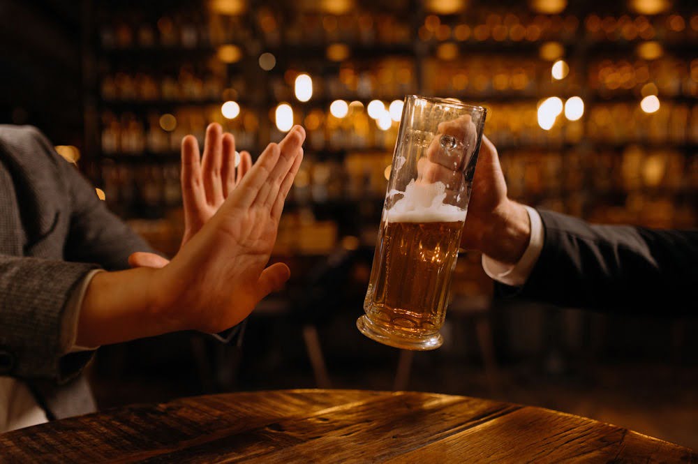 Hand refusing alcohol as a reminder for drug and alcohol rehabilitation