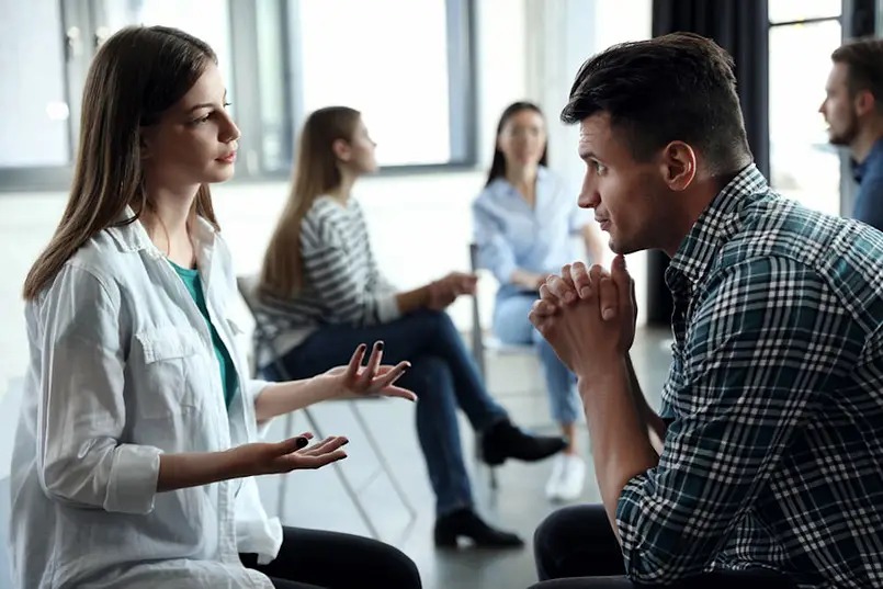 a man and woman sitting in a circle