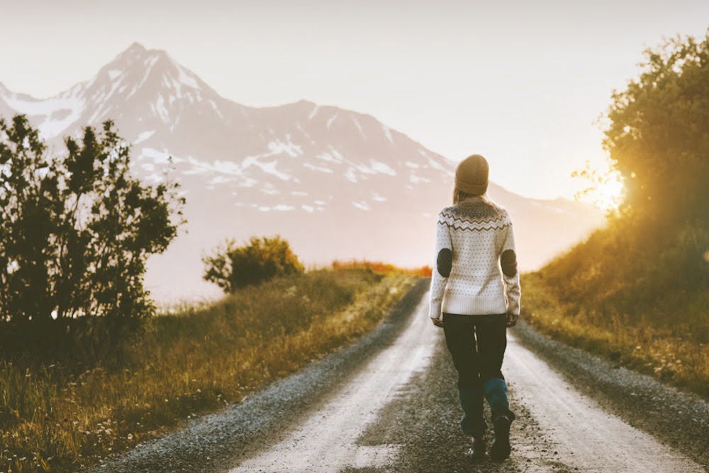 a girl walking on a road