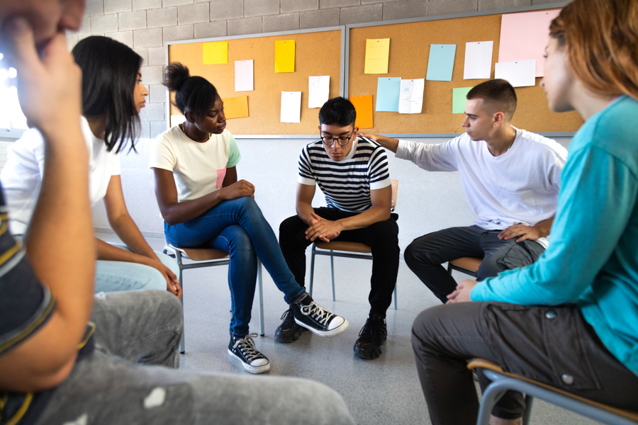 a man having panic attack in a group meeting