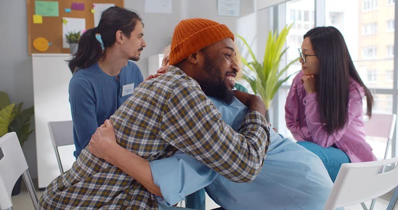 a man hugging another man