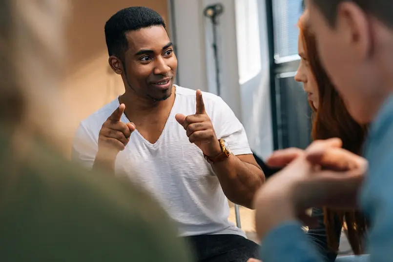 a man pointing his fingers upwards