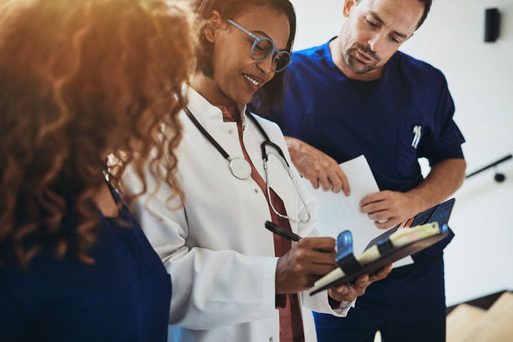medical team reviewing a chart