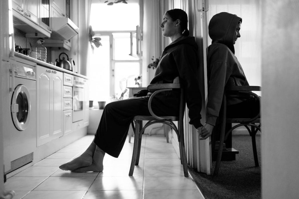 a couple holding hands sitting back to back