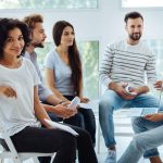 woman and small group in therapy for addiction