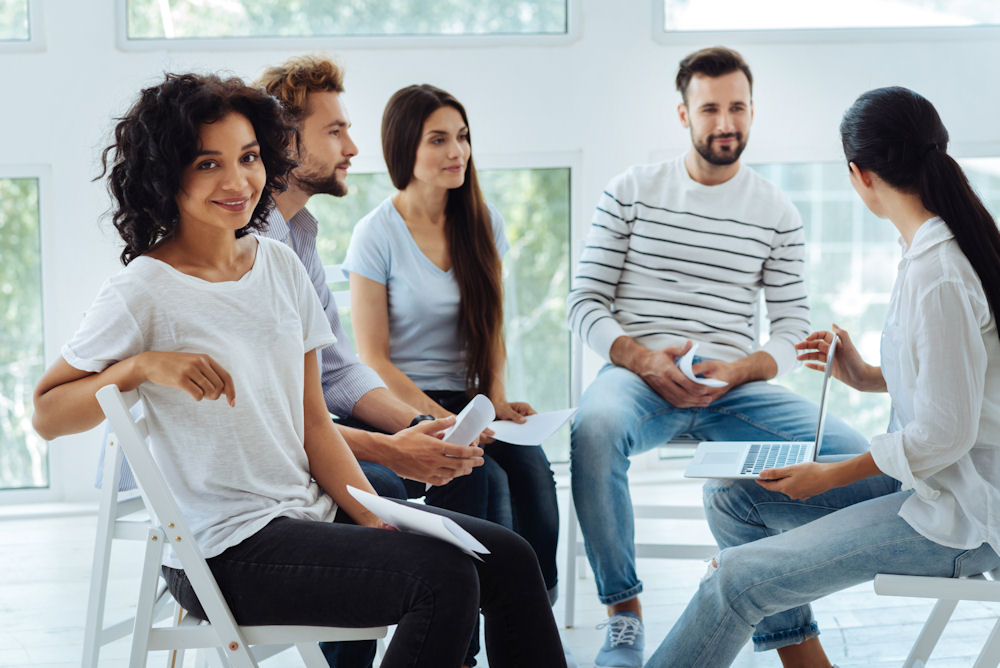 woman and small group in therapy for addiction