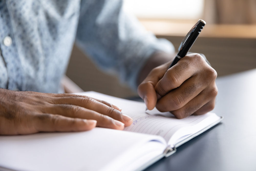 Man journaling during recovery
