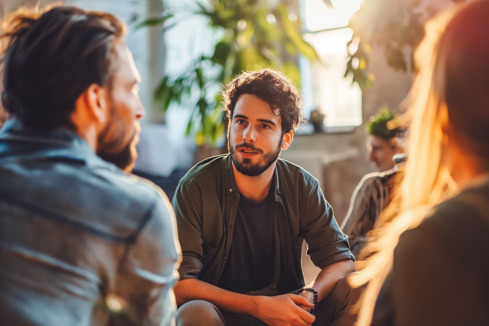 a man sitting during group therapy