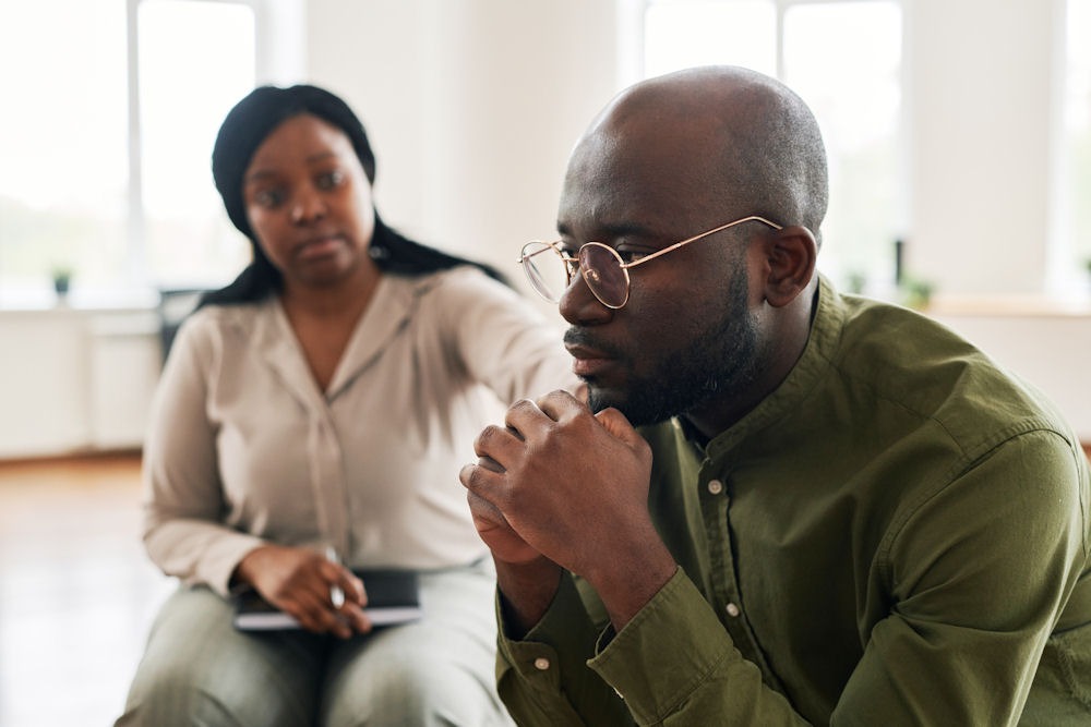 a man being comforted in therapy