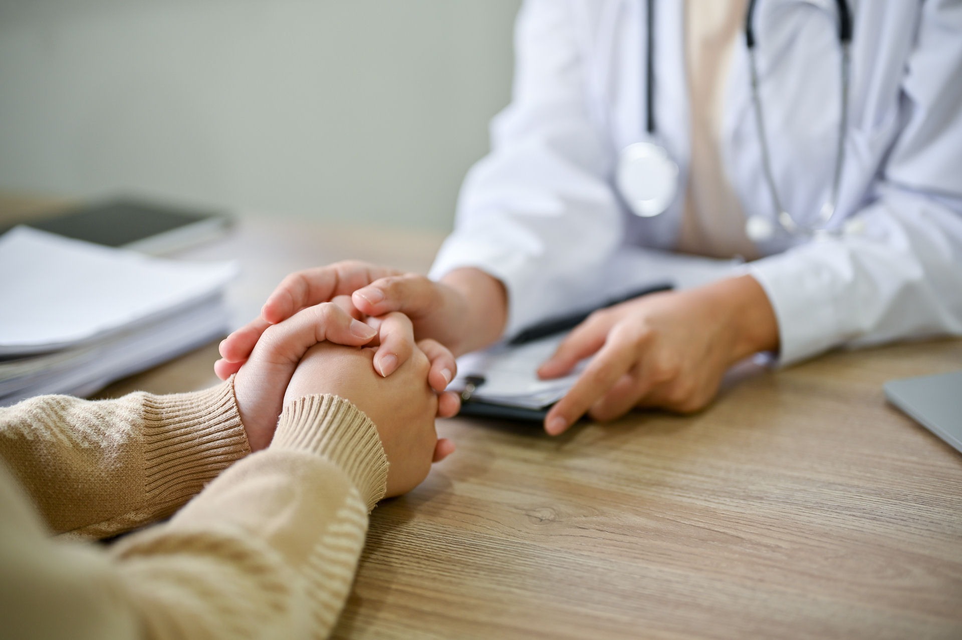 a health expert holding the hand of a patient
