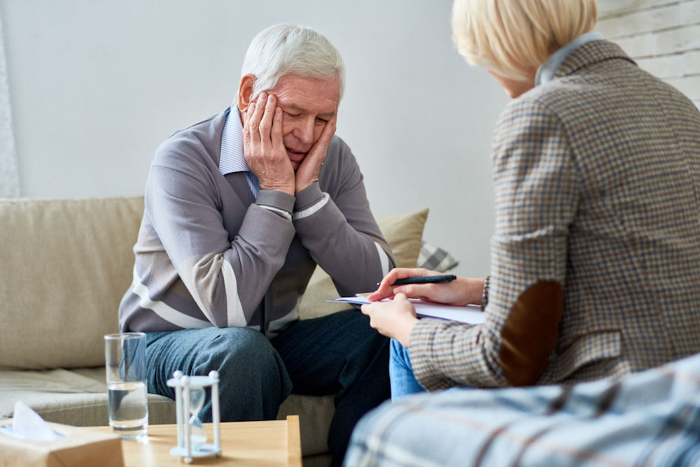 a-senior-man-with-hands-on-face-in-therapy