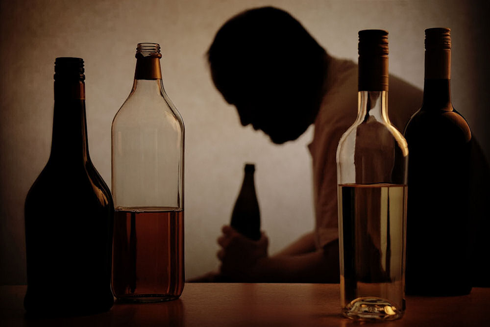 an-older-man-surrounded-by-alcohol