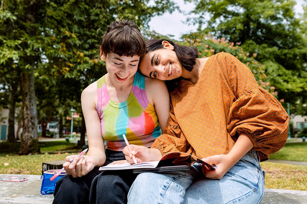 two women working closely together