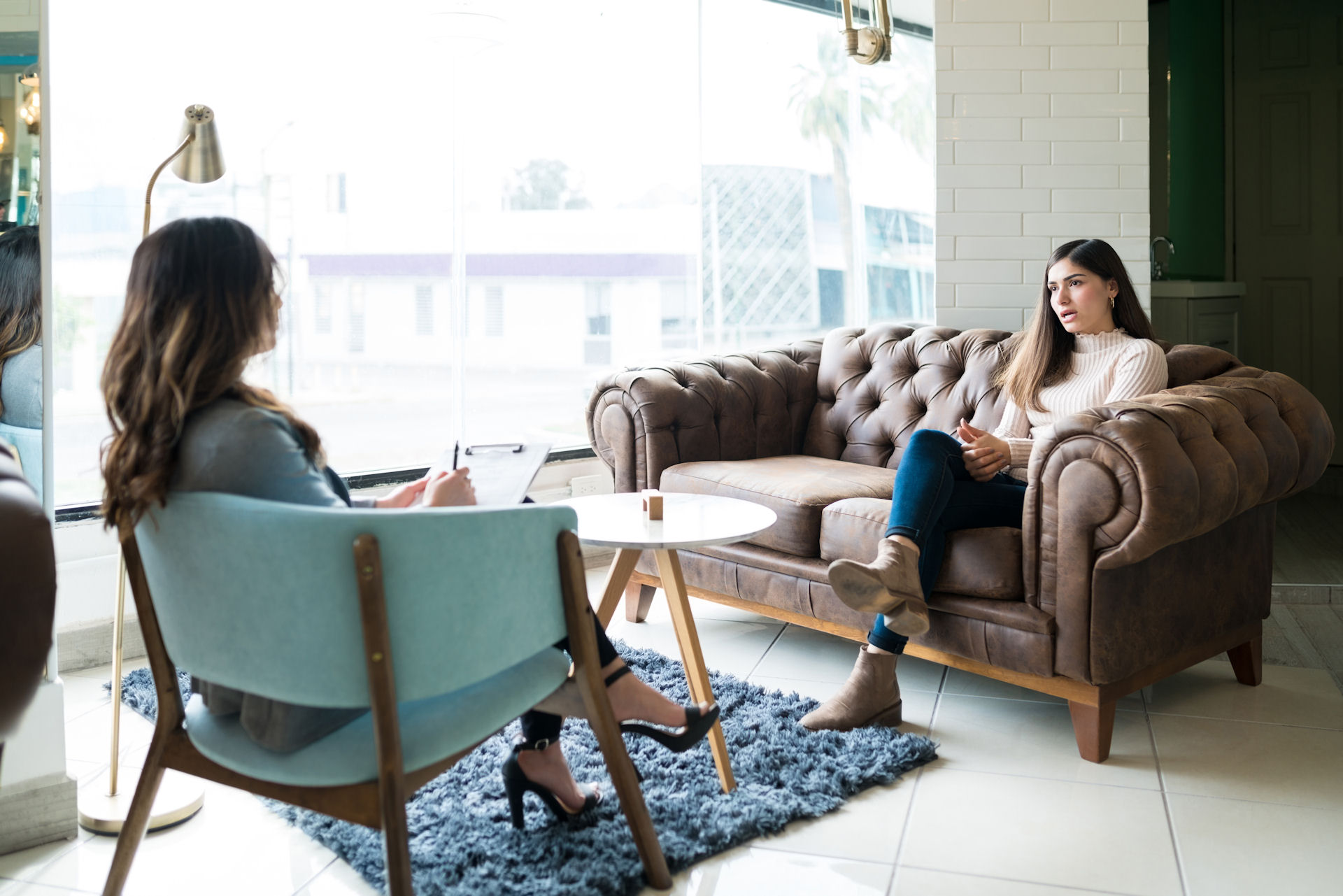 Individual discussing with her therapist how to manage rehab payments