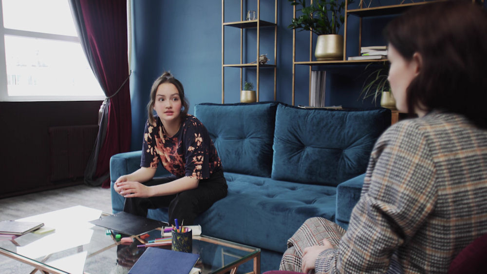 woman sits with therapist during a counseling session