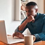 a-man-thinking-on-the-laptop