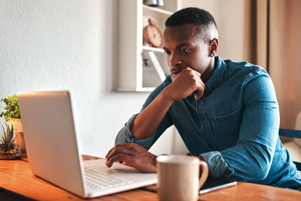 a-man-thinking-on-the-laptop