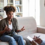 a-woman-with-hands-raised-in-therapy