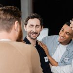 a-man-smiling-in-group-therapy