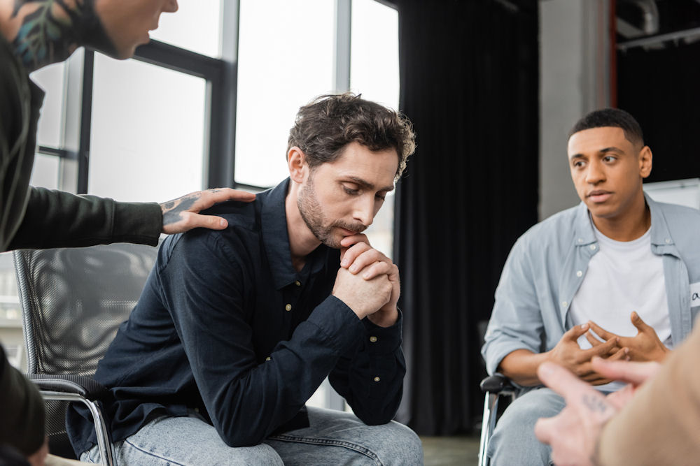 a-man-being-comforted-in-therapy