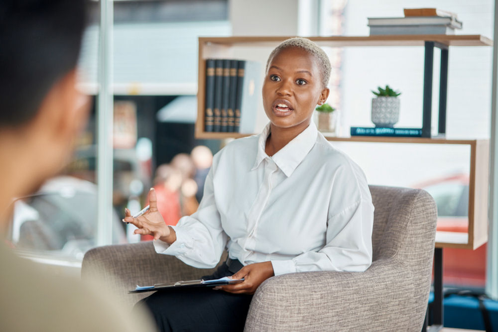 a-woman-speaking-in-a-meeting