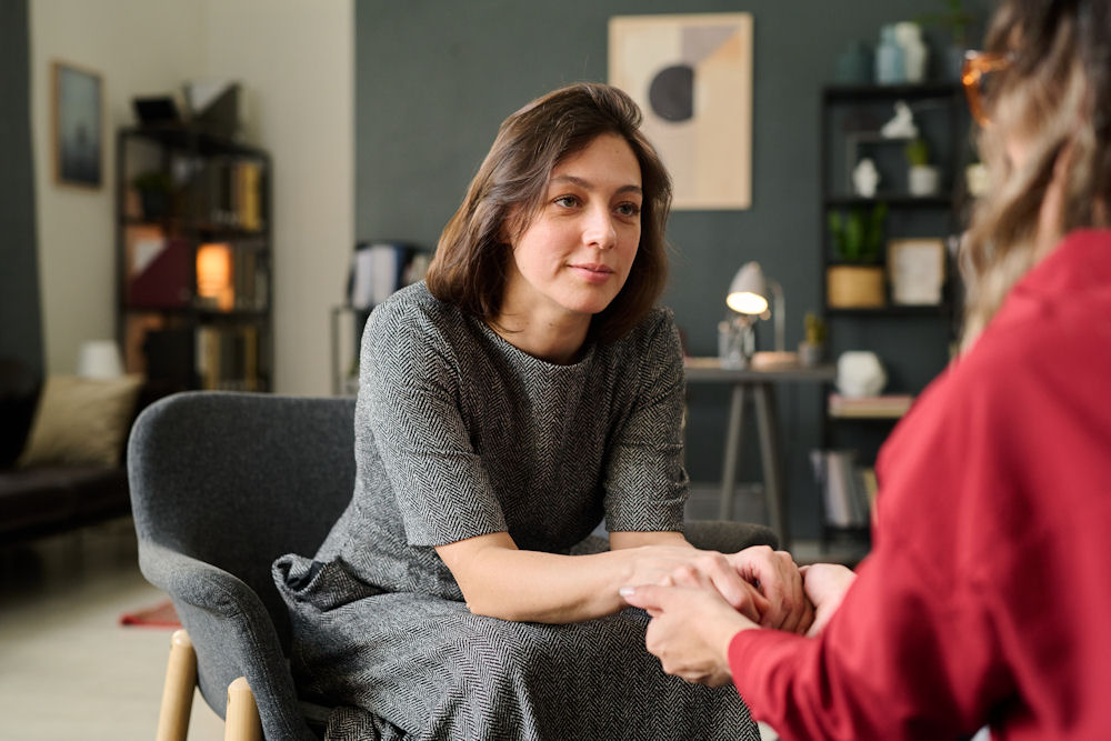 a-therapist-holding-patient-hands-in-session