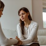 female therapist helping depressed woman heal from childhood trauma in adulthood