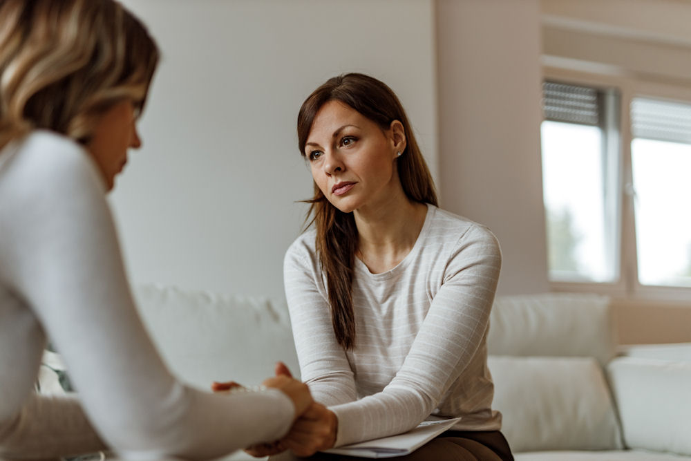 female therapist helping depressed woman heal from childhood trauma in adulthood
