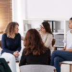 Group therapy session focused on recovery activities that encourage peer support, communication, and shared healing.