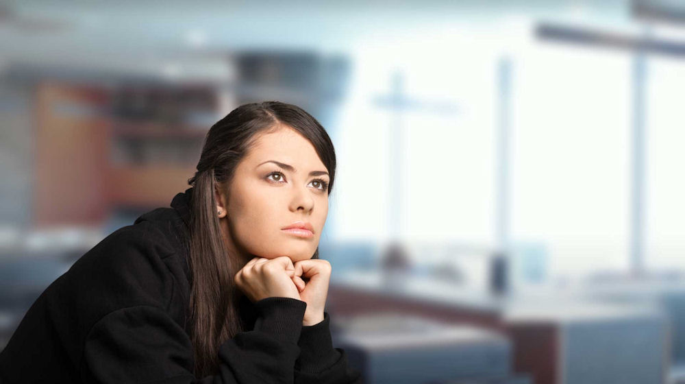 a-woman-staring-up-deep-in-thought