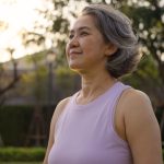 Middle-aged woman practicing self-care during a peaceful walk outdoors, reflecting resilience and emotional balance amid depression and menopause.