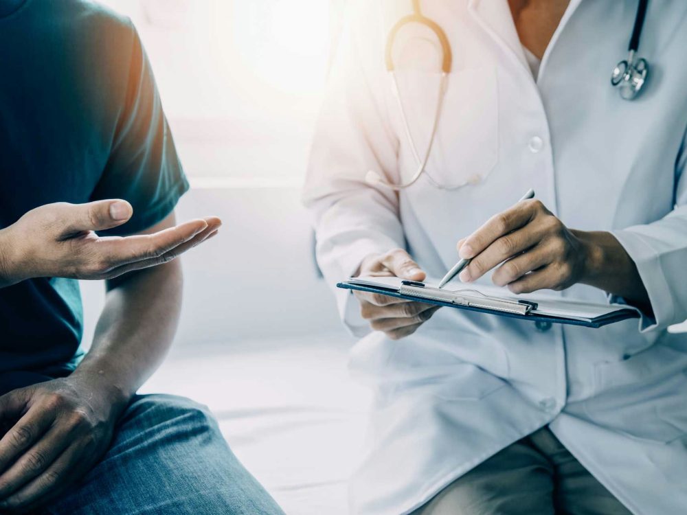A patient is asking some questions to his doctor at a rehab in Medford, Oregon