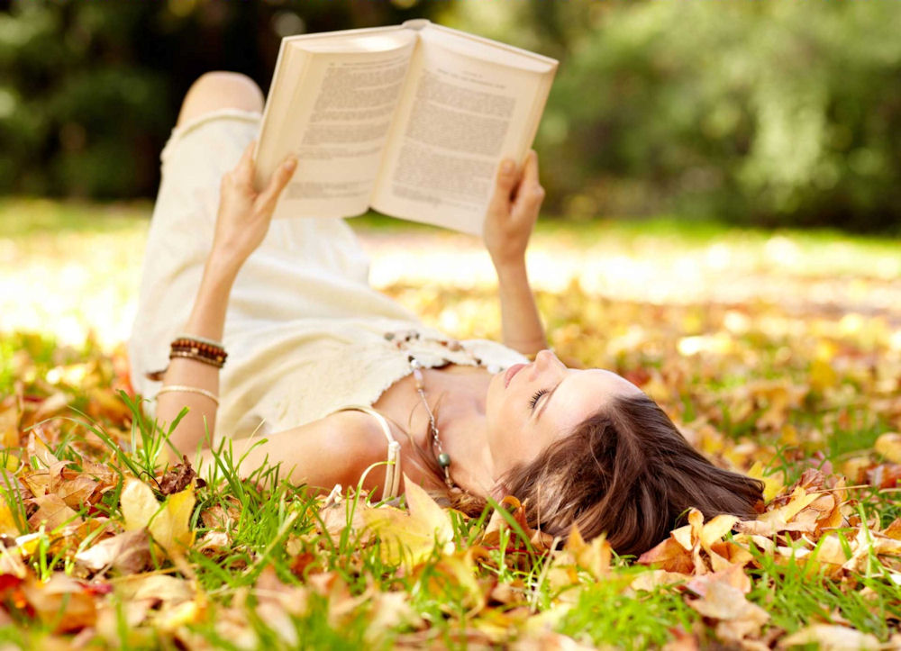 a-woman-reading-laying-in-the-grass