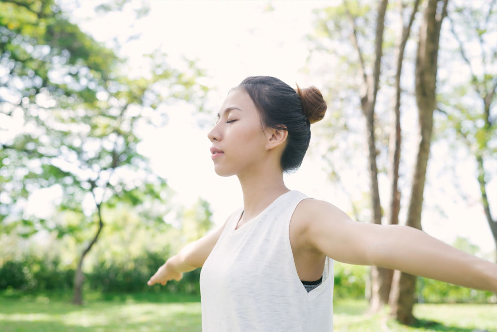 a-woman-stretching-outside-in-nature