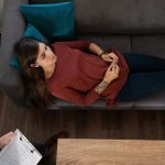 a-woman-laying-down-on-couch