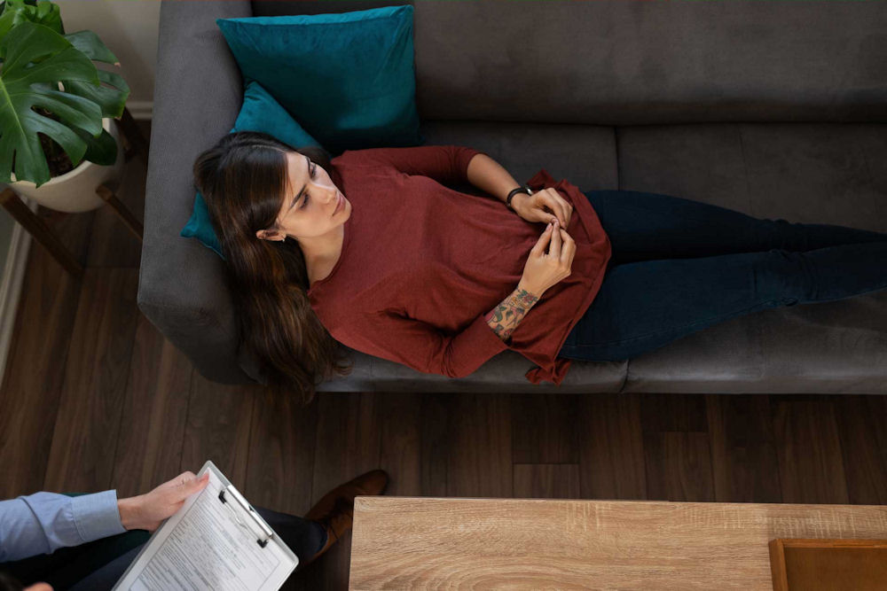 a-woman-laying-down-on-couch