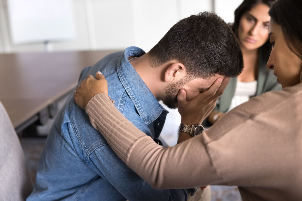 a-man-being-comforted-in-therapy