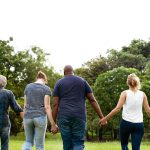 a-group-of-individuals-holding-hands