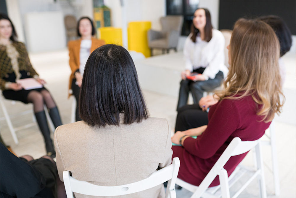 a-group-of-women-sitting-in-therapy