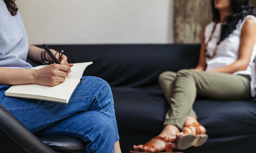 a-woman-sitting-on-a-couch-in-therapy